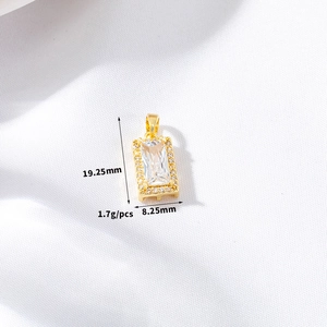Detail view of gold rectangle pendant with transparent gemstone and dimensions 19x8mm