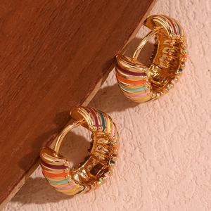 Macro detail of 18K gold plated hoop earrings with vibrant colorful enamel stripes