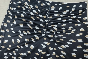 Detail of ruched black fabric with white polka dots on these stylish women's slim pants