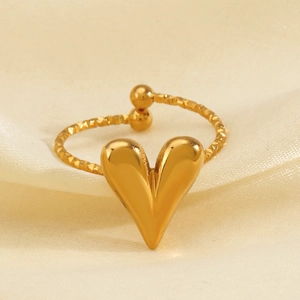 Fashionable gold heart open ring with twisted rope texture on a soft silk background