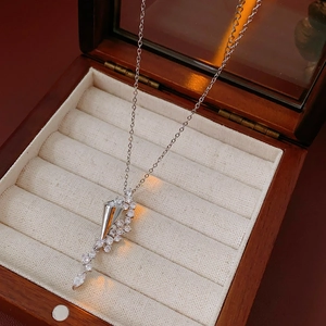 Detail of silver hourglass pendant with cubic zirconia on a luxury wooden gift box
