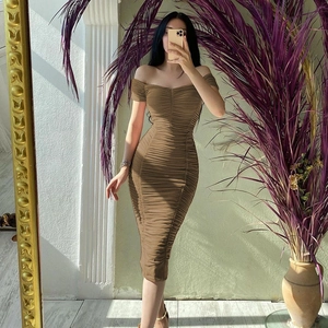 Detailed view of the brown off-shoulder dress featuring pleated texture and slim fit design