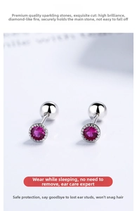 Close-up of silver screw back stud earrings featuring rose red zircon in a six-prong setting