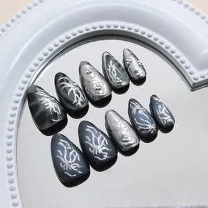Dark metallic almond press-on nails with 3d silver relief texture and chrome finish