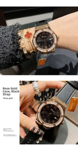Detail view of rhinestone rose gold watch with black dial and leather strap with clover jewelry