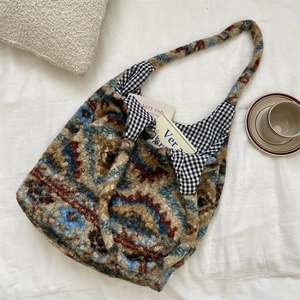 Detail view of vintage plush tote bag with jacquard pattern and check lining for autumn