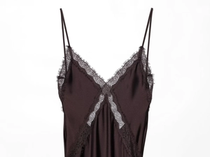 Close-up of fine eyelash lace trim and premium satin fabric on a midi slip dress