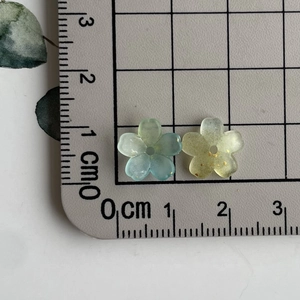 Close-up of 1.5cm gradient resin flower beads in teal and lime green with center holes