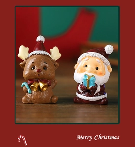 Close-up of resin Santa Claus and reindeer figurines for Christmas tabletop decor