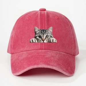 Close-up of vintage washed rose red baseball cap with cute peeping cat graphic print