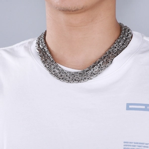 Close-up of heavy silver snake chain necklace with woven texture and metallic luster