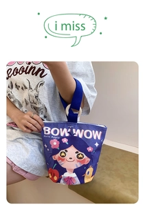 Detail of purple canvas bucket bag with cartoon girl print and sturdy blue ribbon handle