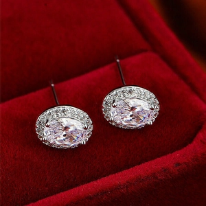 Detail of oval cubic zirconia stud earrings in a red velvet jewelry box