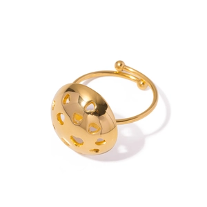 Gold-plated domed open ring featuring hollow heart patterns on a polished metal surface