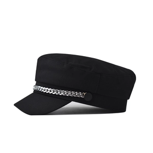 Classic black newsboy cap with silver chain detail on a minimalist retro baker boy hat