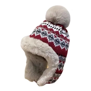 Red jacquard knit trapper hat with gray faux fur lining and pompom for winter warmth