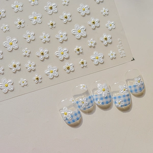 Detailed 3D floral nail art stickers with white flower petals and golden bead accents