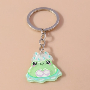 Close-up of cute cartoon frog keychain with cloud pattern and pink heart details