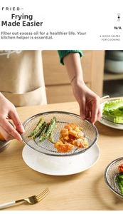 Close-up of stainless steel frying basket with handle for kitchen oil draining