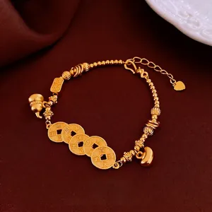 Golden beads bracelet with Wu Di coins and gourd pendant on red velvet background