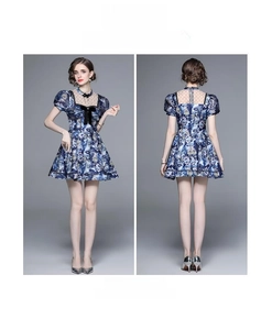 Blue floral mini dress detail with bubble sleeves, black bow, and lace mesh neckline