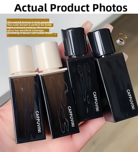 Close-up of set of four velvet matte lip glazes in square brown and black tubes