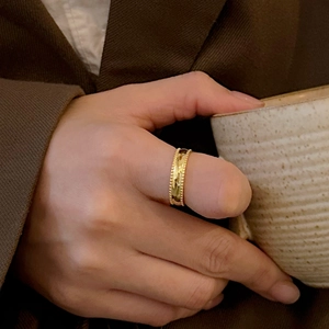 Minimalist 925 sterling silver beaded ring in gold finish worn by model holding a cup
