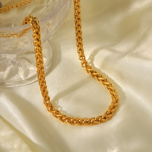 Elegant 18K gold plated stainless steel wheat chain necklace on silk background