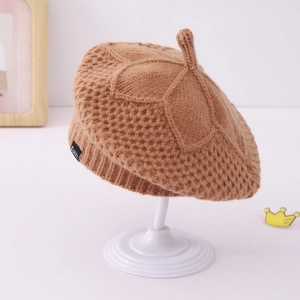 Detail of caramel brown knitted pumpkin beret showing honeycomb weave and petal pattern