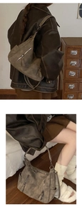 Detailed macro view of vintage taupe suede tote bag with metallic zipper and matte texture