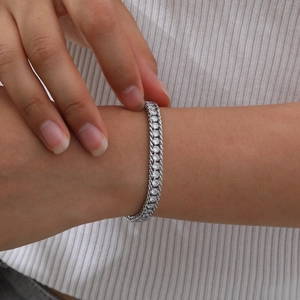 Detail of silver cuban chain bracelet with pavé cubic zirconia worn on wrist