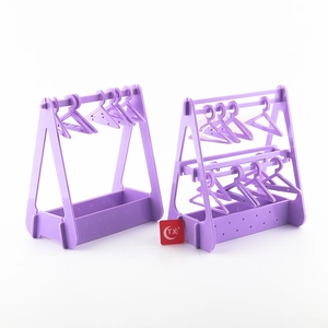 Purple acrylic earring organizer featuring mini clothes hanger racks for jewelry storage