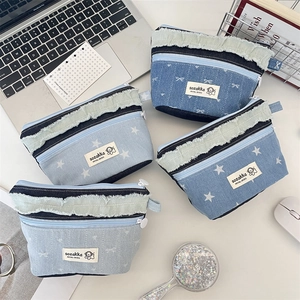 Minimalist denim cosmetic bag with star and bow embroidery in blue patchwork denim style