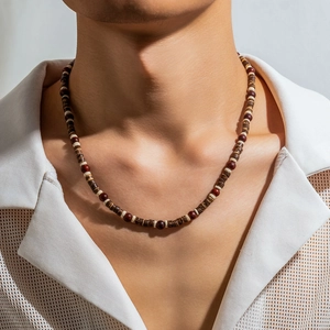 Men's bohemian wooden bead necklace with rustic brown and beige tones on a male model