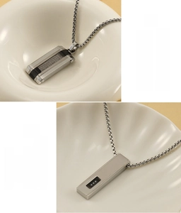Detail of hip hop stainless steel pendant necklace with zircon and black inlay details