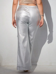 Women's metallic silver high waist wide leg pants showing back view in studio light