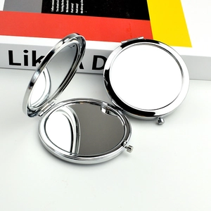 Polished silver metal round folding makeup mirror shown in open and closed views