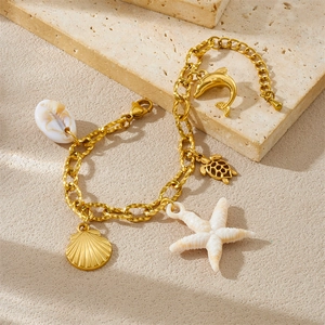 Gold stainless steel chunky chain bracelet with sea star and turtle charms on sand