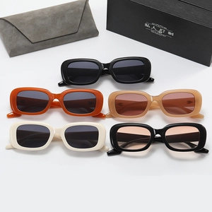 Flat lay of retro rectangle sunglasses in various colors with luxury packaging boxes