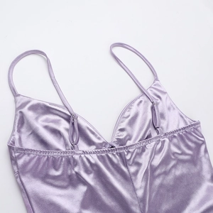 Detail of adjustable straps and stitching on a purple satin V-neck dress