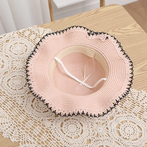 Pink straw sun hat featuring black lace trim and adjustable windproof inner strap