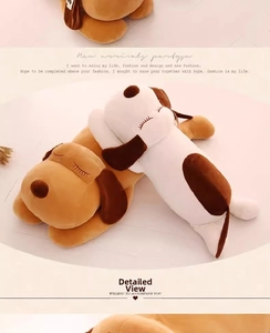 Detail of plush puppy pillow showing soft fabric texture and closed-eye facial stitching