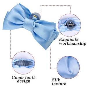 Detail of light blue silk bow hair claw showing comb tooth design and soft texture