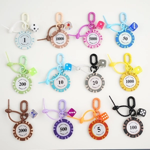 Close-up of colorful poker chip keychains with dice and spiral cords in a professional array
