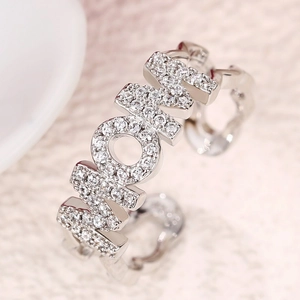 Detailed close-up of MOM open ring with pavé-set zircons and polished silver finish