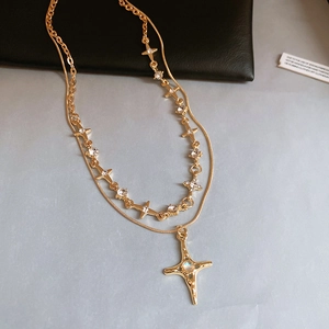 Double-layered gold star necklace featuring a celestial pendant and iridescent gemstone