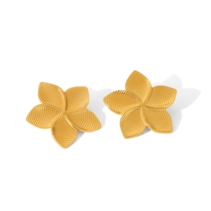 Detail of 18K gold flower earrings with brushed metal texture on white background