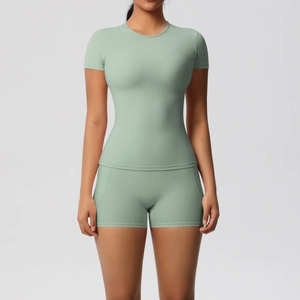 Detailed front view of high-waist mint green yoga shorts and tight short sleeve top