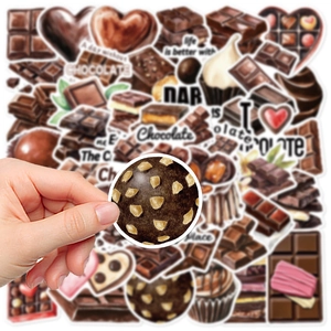 Hand holding a waterproof chocolate-themed sticker for journals and luggage decoration