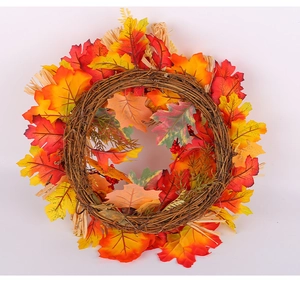 Detail of harvest wreath with maple leaves, pine cones, and berries on natural rattan